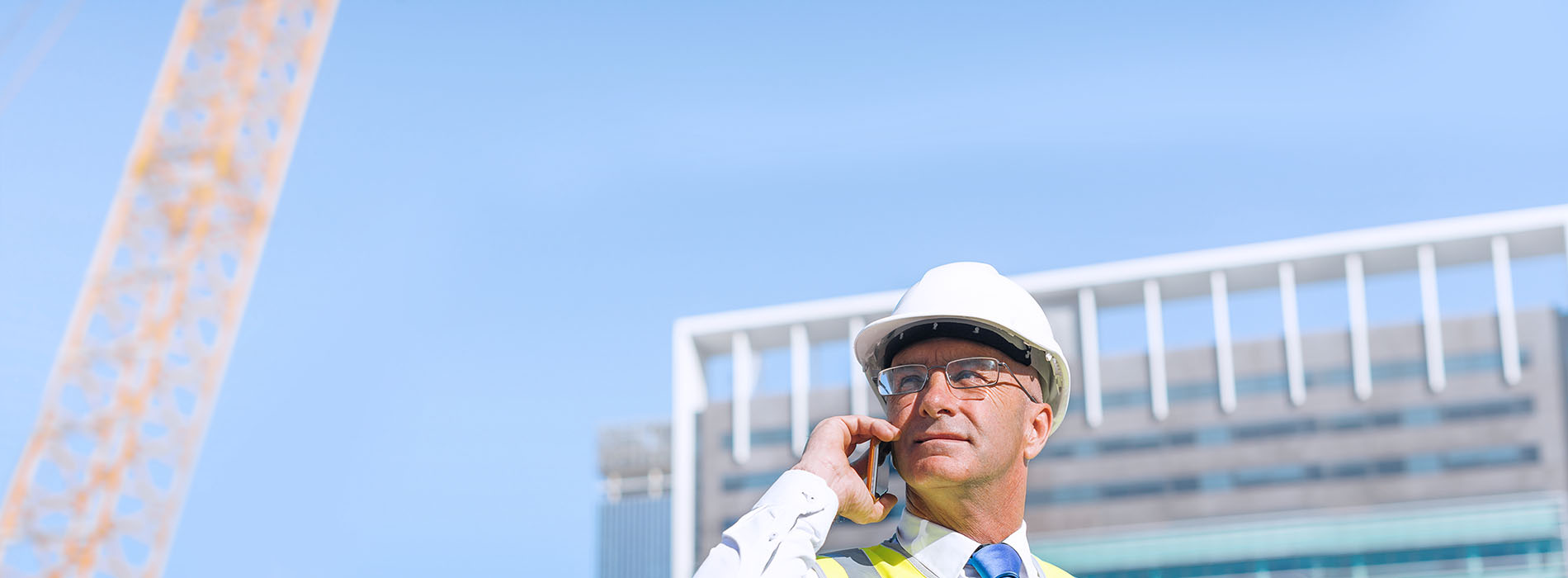 Construction worker talking on smartphone