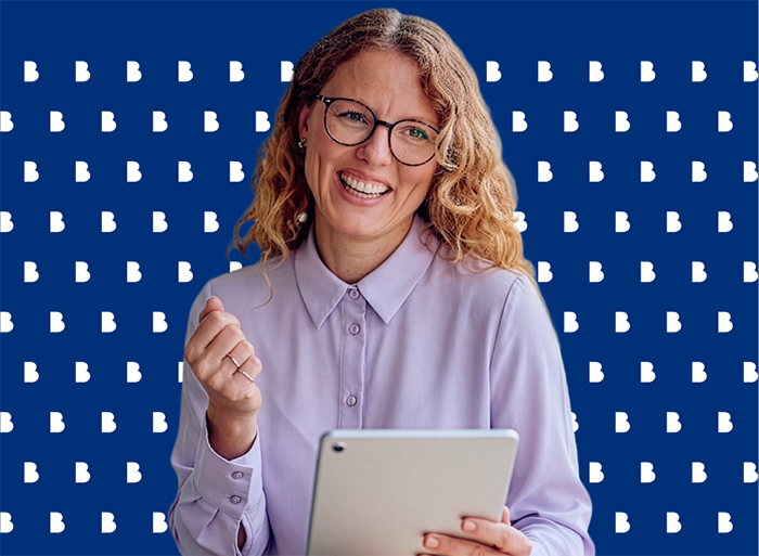 A professional woman holding a tablet and smiling, reading professional and managed services insights.
