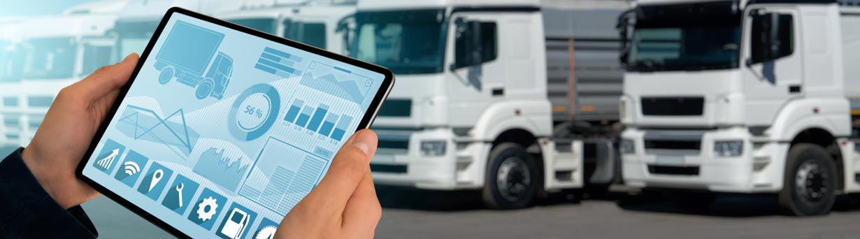 A fleet manager reviews vehicle telematics and driver behaviour data on a tablet to inform data-driven maintenance and coaching.